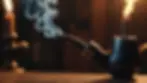 Close-up view of a lit pipe with smoke curling up