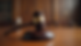 Close-up view of a courtroom gavel on a wooden desk