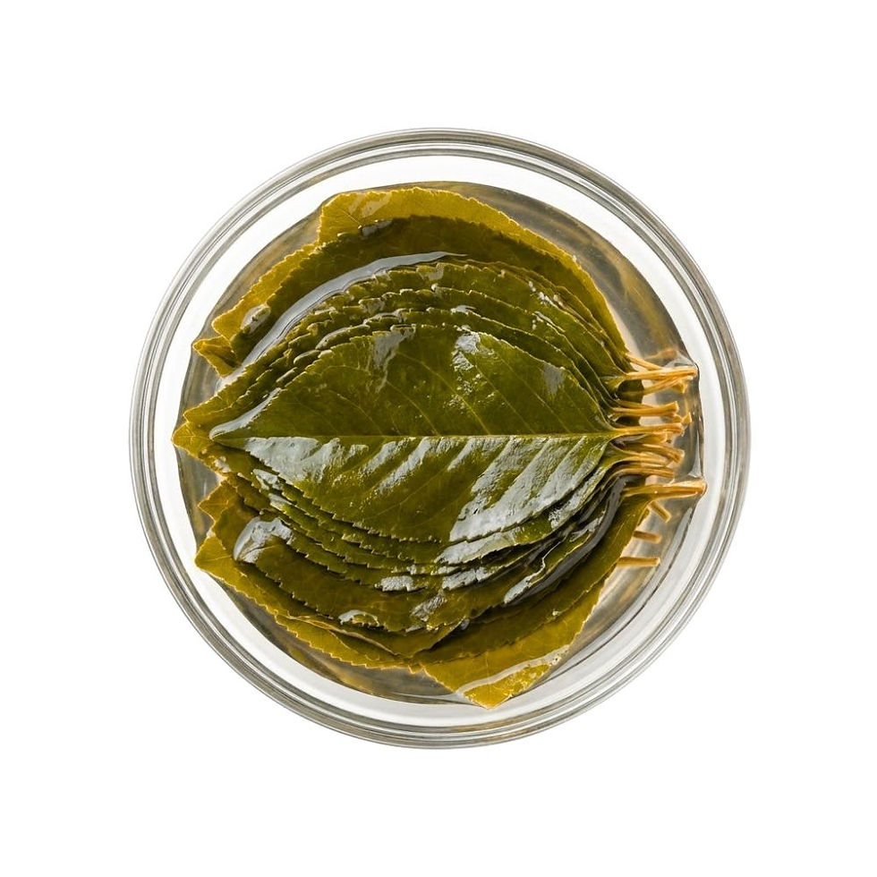 Cherry Leaves in Brine arranged in a shallow glass bowl, square studio shot on a pure white background.