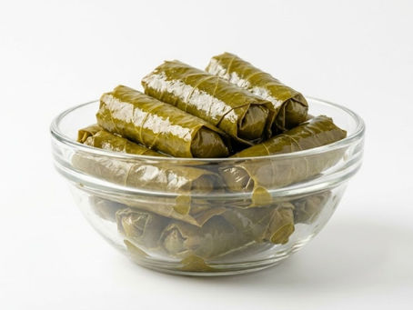 Grape Leaves in Brine displayed in a clear glass bowl on a white background.