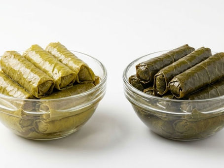 Grape leaves in brine displayed in bowls highlighting color and texture differences.