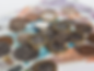Coins and banknotes scattered, featuring various British pound denominations. The image is bright, with a neutral background.
