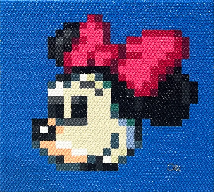 Pixel art of Minnie Mouse with a red bow on a blue bubble wrap background.