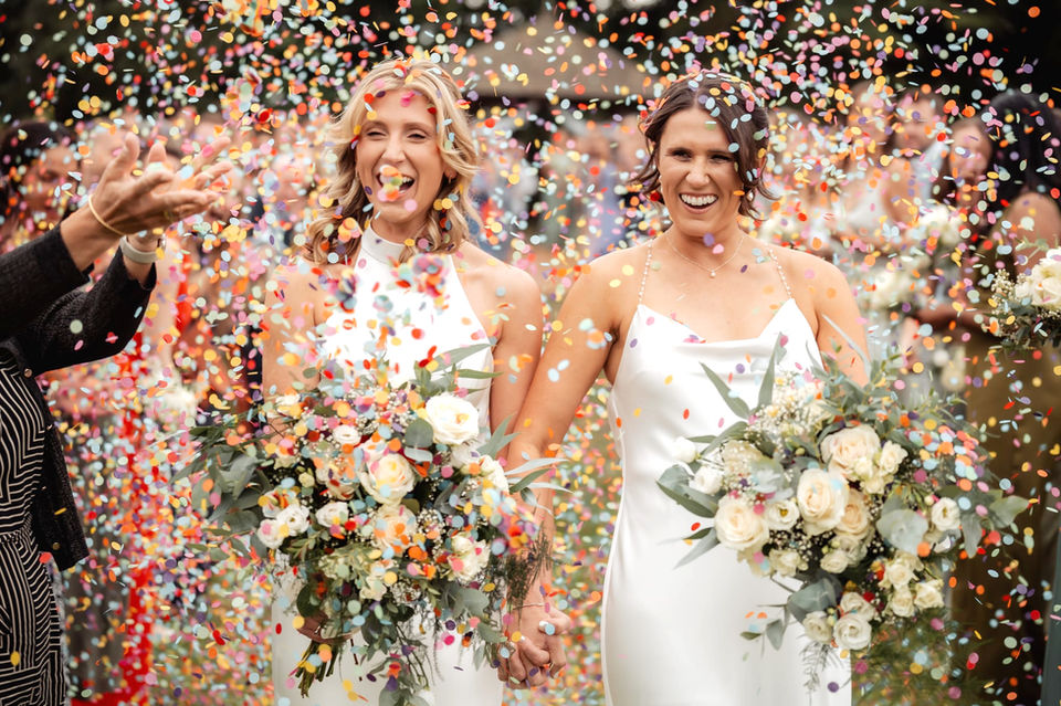 Bride and Bride under confetti at Great Lodge