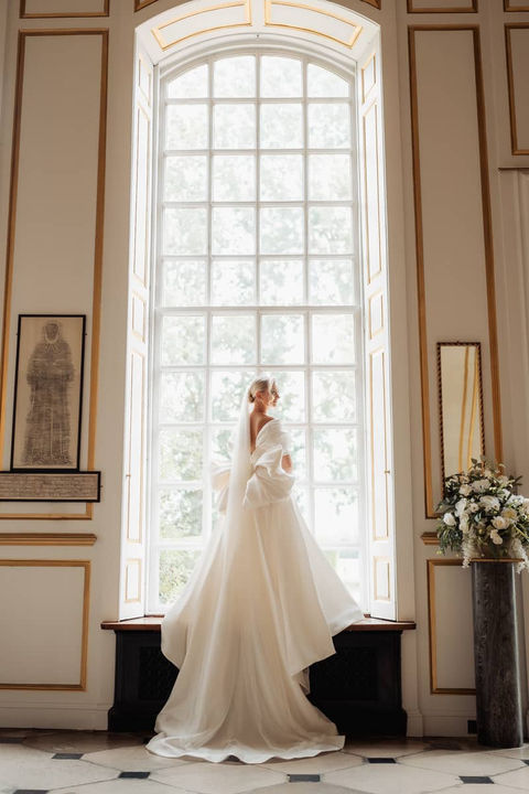 Bride in large window at Gosfield Hall