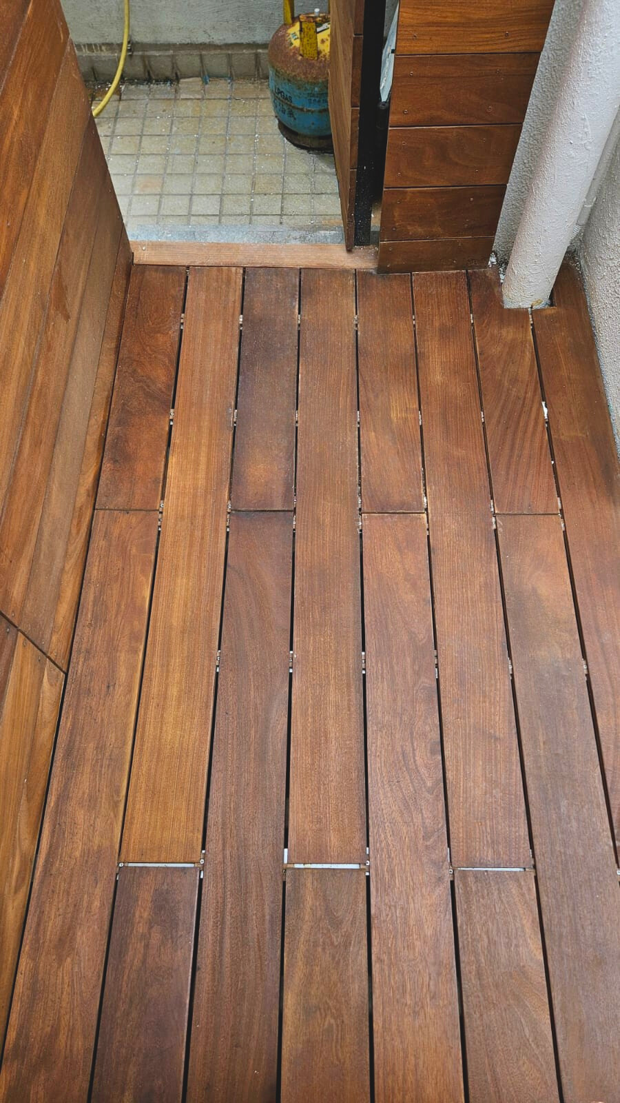 Outdoor Teak solid wood deck flooring in modern Hong Kong residential space, featuring natural hardwood planks with high durability and elegant finish