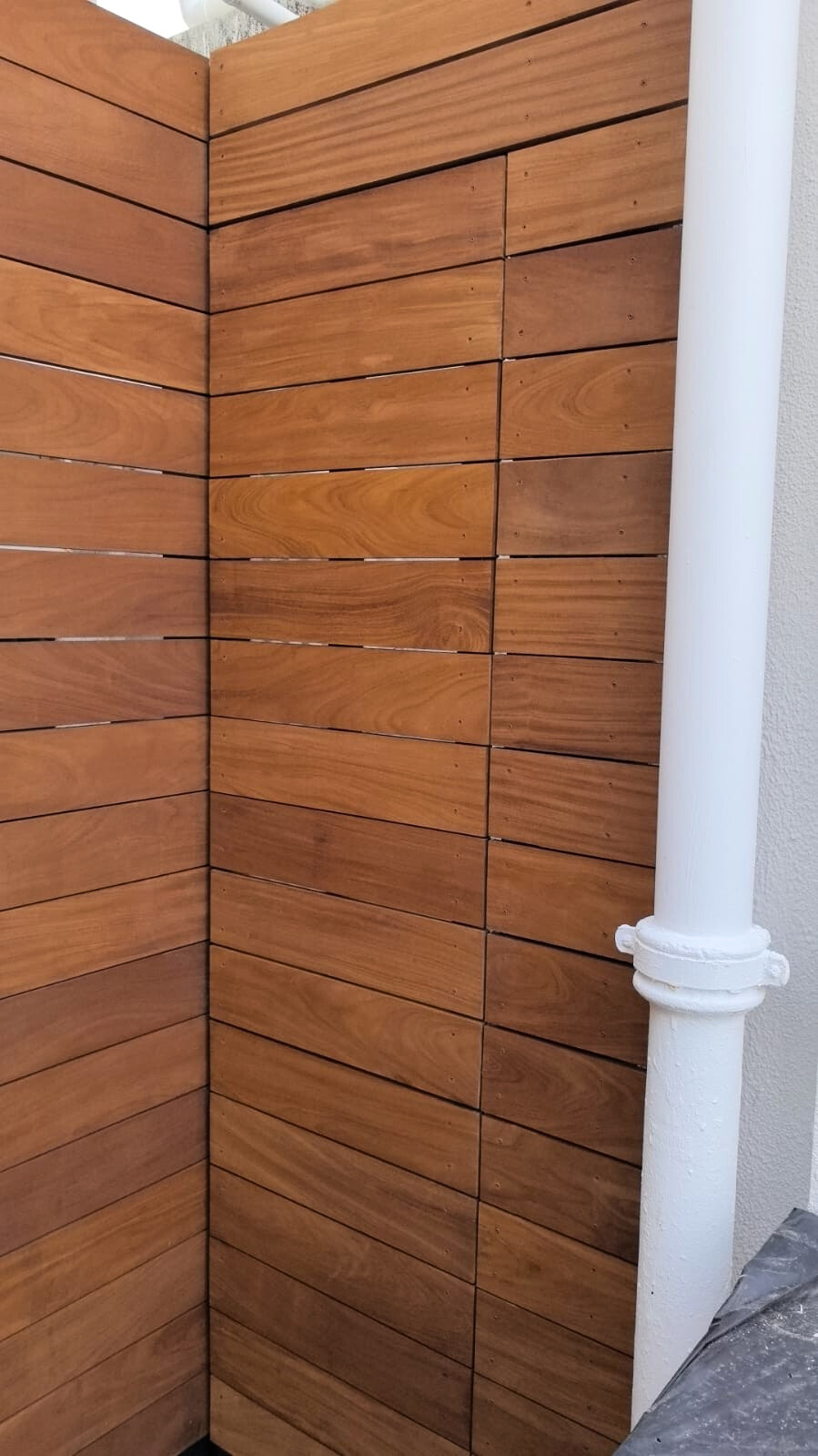 Premium Teak solid wood privacy fence installation for outdoor area, showcasing smooth timber panels and quality craftsmanship in Hong Kong architecture