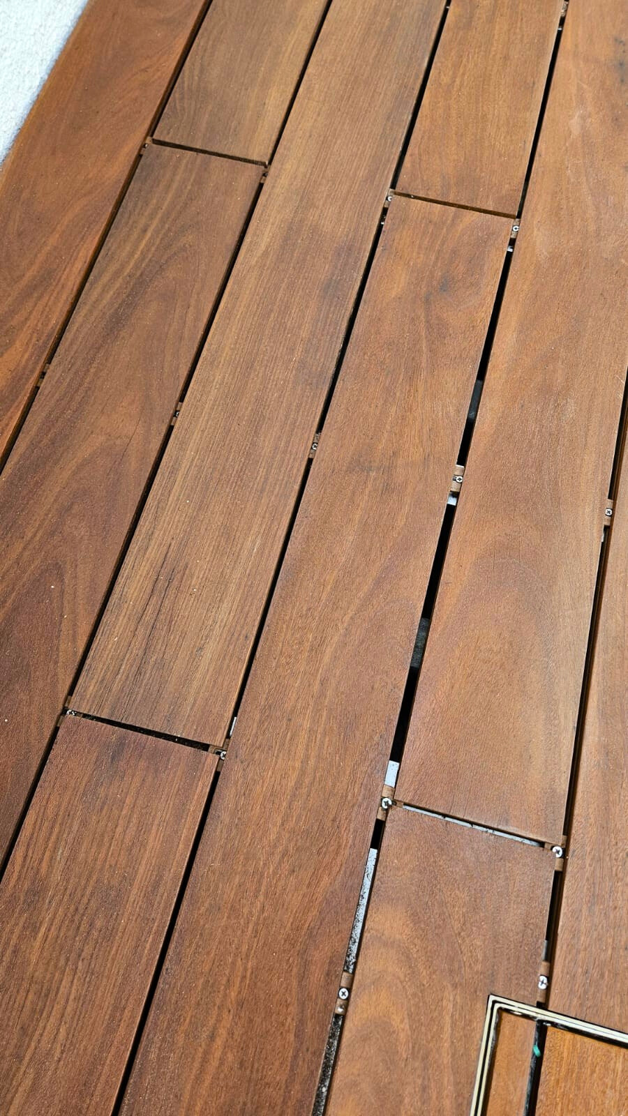 Outdoor Teak solid wood deck flooring in modern Hong Kong residential space, featuring natural hardwood planks with high durability and elegant finish