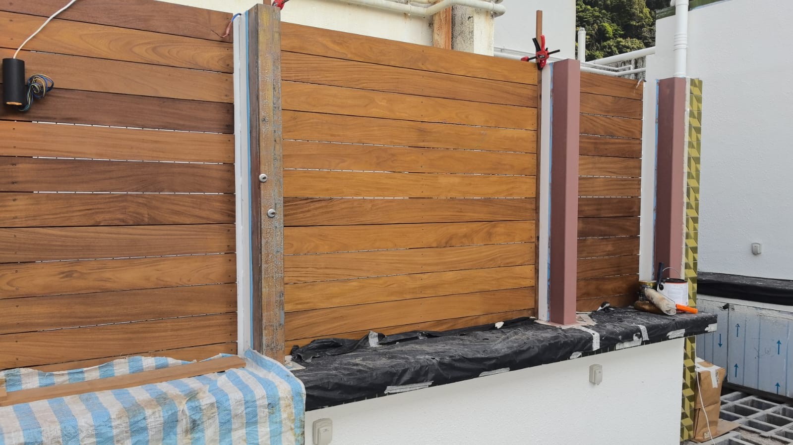 Premium Teak solid wood privacy fence installation for outdoor area, showcasing smooth timber panels and quality craftsmanship in Hong Kong architecture