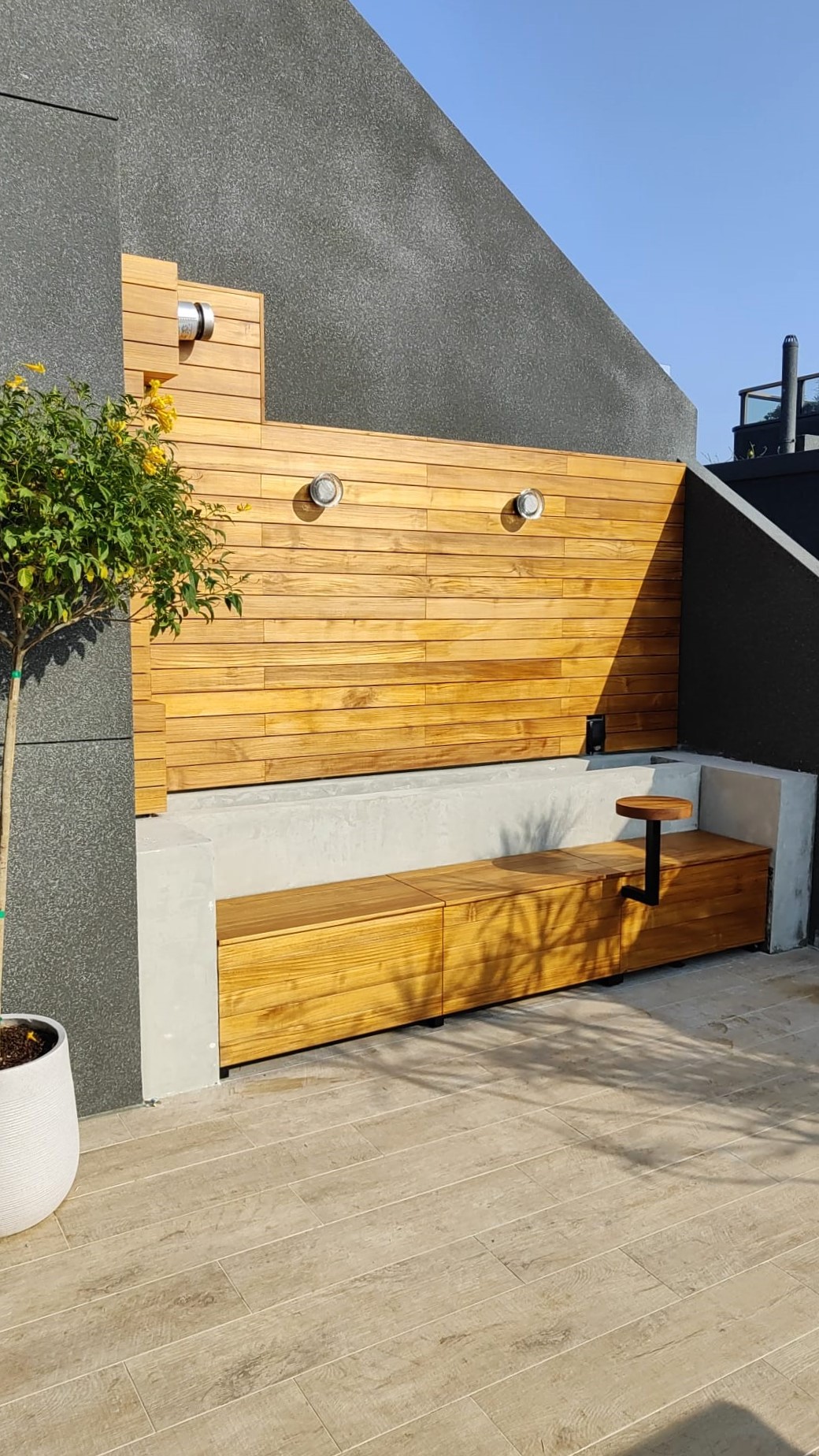 Wood cladding and outdoor bench seating made with Teak
