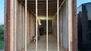Image of a container home with 2x4 wood interior framing