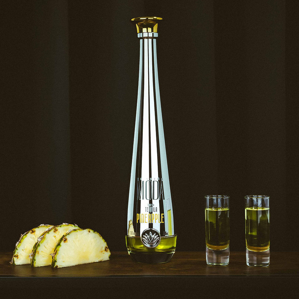 Thumbnail: A bottle of MODA Tequila Pineapple positioned next to shot glasses filled with flavoured Tequila and pineapple fruit.