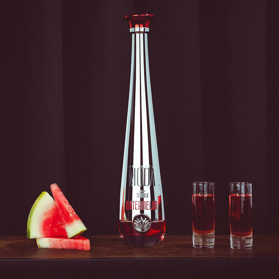 Thumbnail: A bottle of MODA Tequila Watermelon positioned next to shot glasses filled with flavoured Tequila and watermelon fruit.