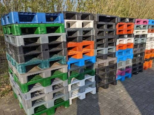 Stacked colorful plastic pallets ready for transport, Plastic Pallets in Various Settings, Pallet Business.