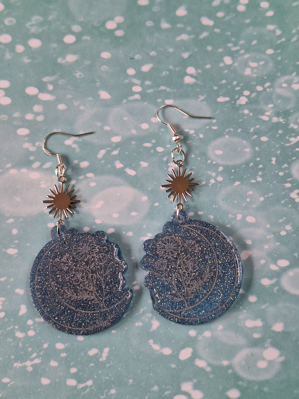 Thumbnail: Handmade blue/silver glitter floral moon earrings on silver plated hoo