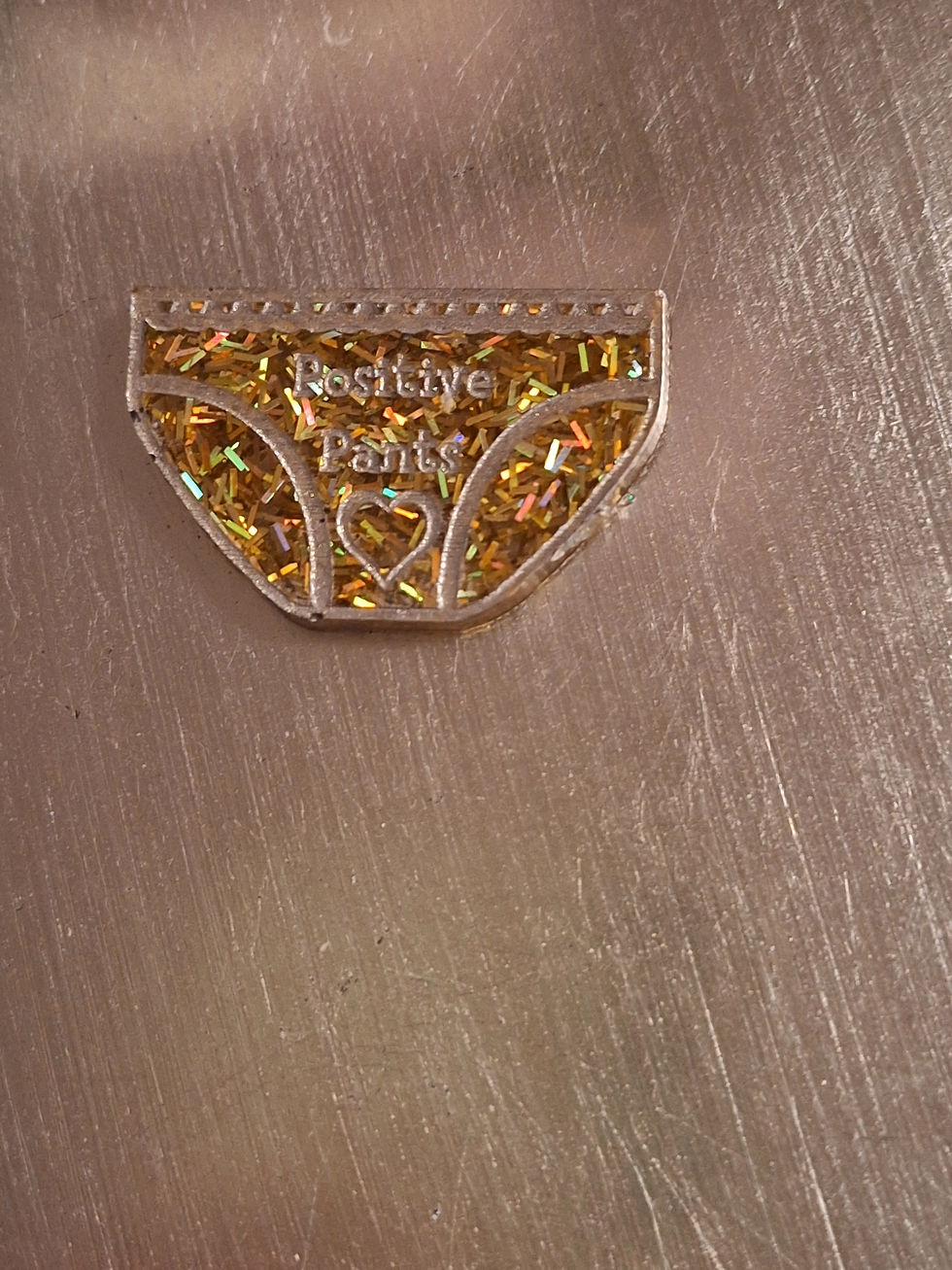 Gold glitter positive pants brooch