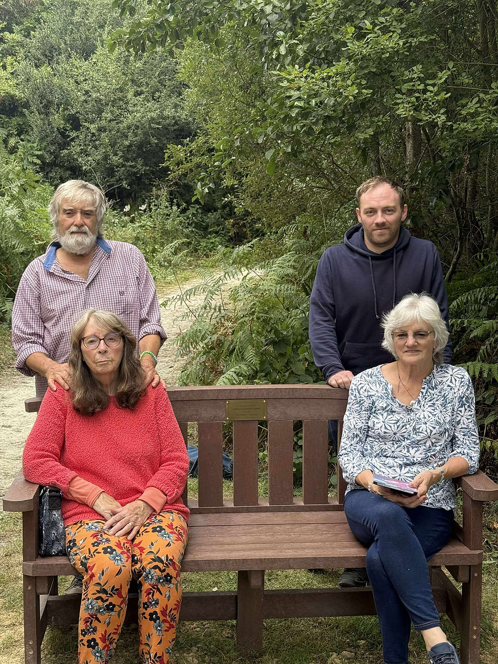 John's memorial bench and family members