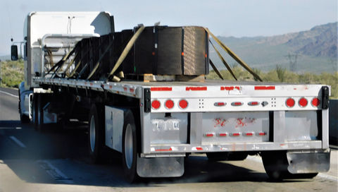 Truck with flat bed with cargo on board