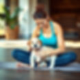 woman doing yoga with a cute puppy.jpg