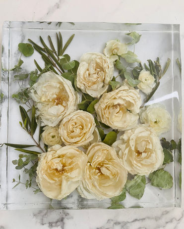 White roses preserved 3D in an a square epoxy resin block