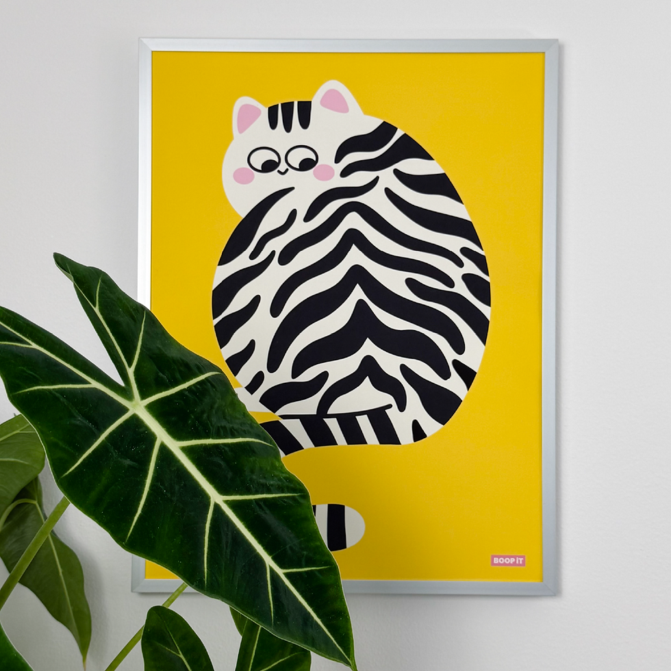 Big Kitty yellow poster with a playful striped cat illustration displayed on a wall.