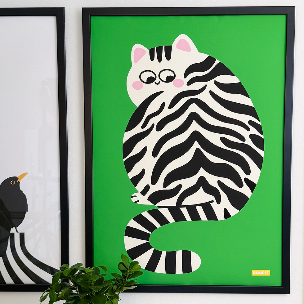 Big Kitty green poster framed on a wall with a plant