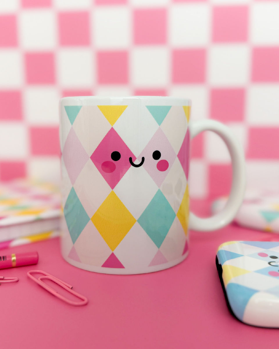 Happy Harlequin coffee mug with pastel diamond pattern on pink checkered background