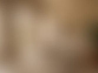 A quiet luxury interior with layered soft furnishings and textured walls — acoustic design by Ironwood Solutions, Riyadh