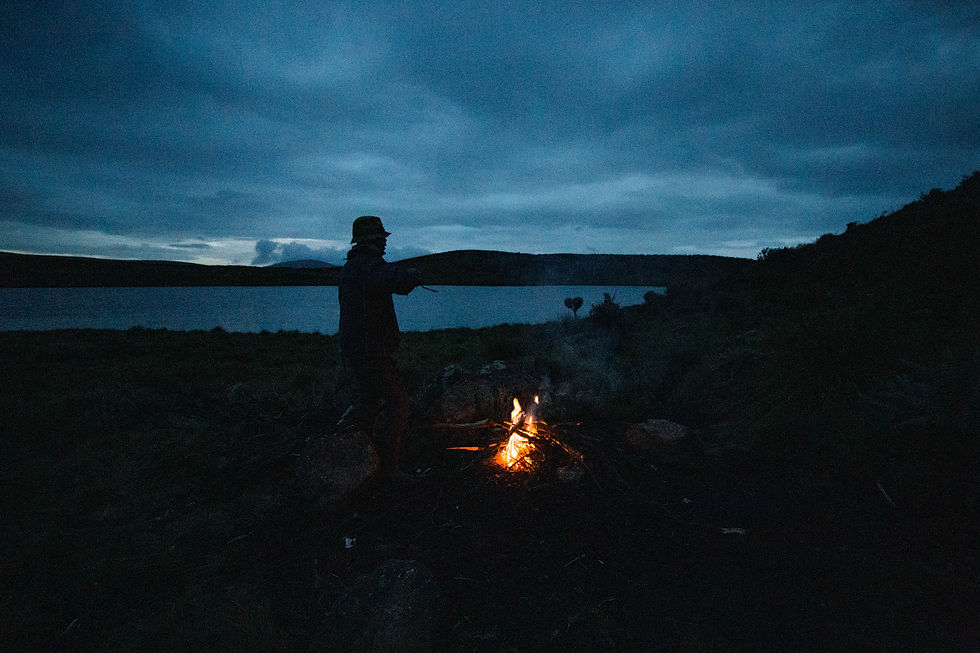 Keeping warm with a campfire, technically not allowed, by Lake Michaelson on Mount Kenya's eastern slopes