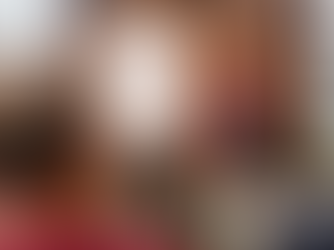 Man in a maroon sweater speaks to an audience, gesturing with a notepad. A flip chart reads "Youth Sport Trust, Rounders England."