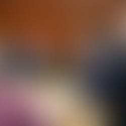 People in a meeting, seated around a table with notepads and water, in a wood-paneled room. One person stands, speaking to the group.