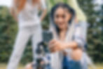 woman-using-video-sharing-app-mobile-phone-while-standing-outdoors-park-with-her-friends-m
