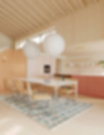 High-end kitchen with soft playful colours and vaulted ceiling