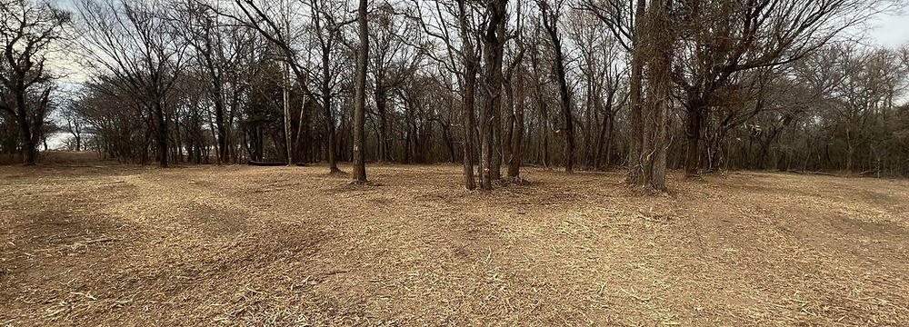 Newly cleared land after professional forestry mulching, showing a clean, level site ready for new construction or landscaping in Bixby, Oklahoma.
