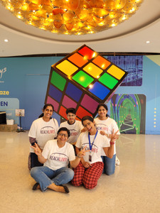 Reach Lives volunteers posing in front of The LGBTQube art installation in Phoenix Marketcity Bengaluru.