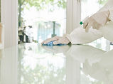 worker-rubber-gloves-wiping-surfaces.jpg