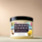 Almond Cookie Body Butter + essential oils in a jar, highlighting its creamy texture and warm almond fragrance.