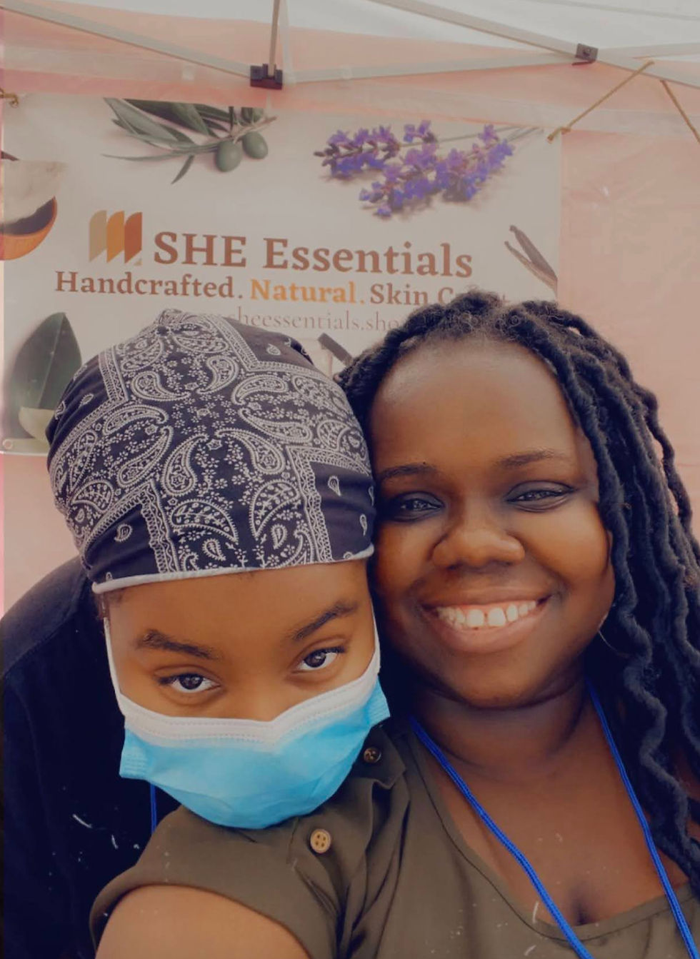 jackie robinson owner of she essentials and daughter at outdoor market