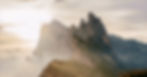 Mountain summit with the sun peaking behind. Regain control over your life.
