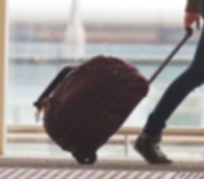 Traveller walking through airport with luggage