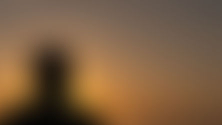 Young man in shadow looking at sunset