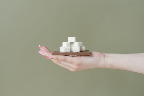 Hand holding sugar cubes