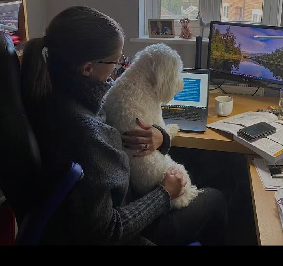 Tina studying her fitness qualification at home with her dog, retraining as a personal trainer over 50