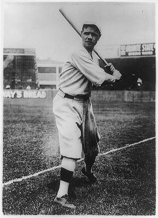 Babe Ruth, full-length portrait in Boston Red Sox uniform holding a bat, 1920