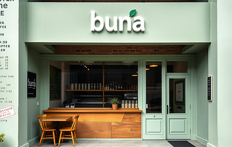 renovated old building into coffee bar with exposed brick and pale green paint and the nam