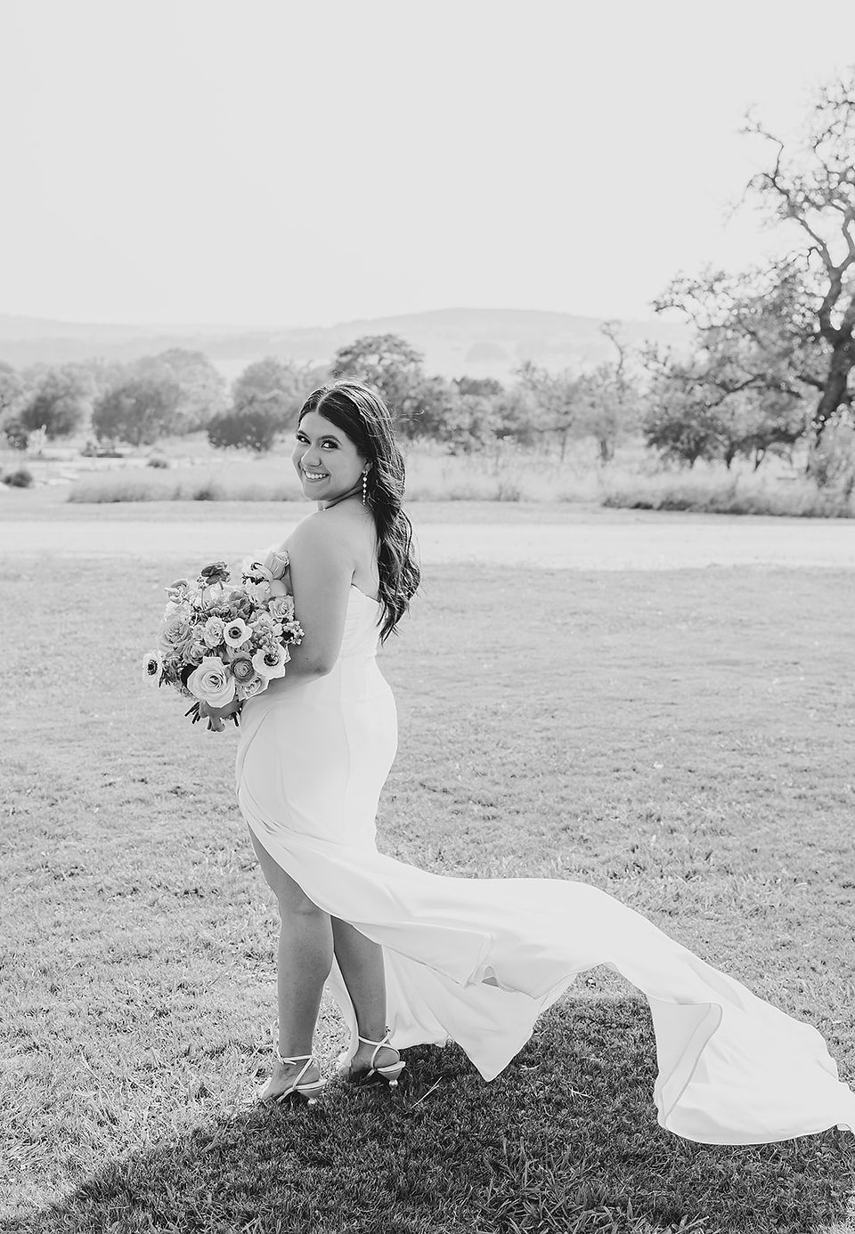 Bride smiling during bridal portrait at Camp Hideaway in Fredericksburg, Texas Hill Country wedding