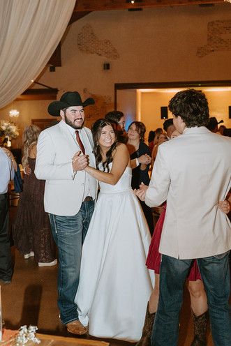 Bride and groom celebrating on the dance floor with family and friends at The Chandelier of Gruene.