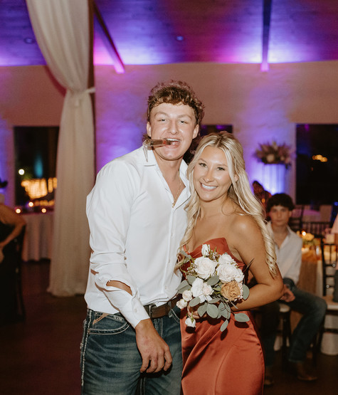 Maid of honor and best man dancing together during the reception celebration.