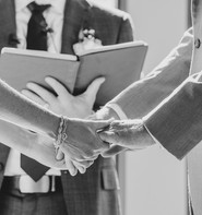 Close-up of bride and groom holding hands during ceremony at Canyonwood Ridge in Dripping Springs, Texas