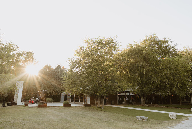 Wide view of the sunset over the outdoor reception at The Waters Point during a Wimberley wedding